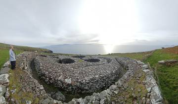 Stone structures in a landscape overlooking the sea.