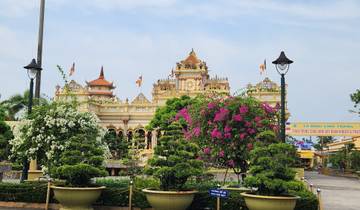 Colorful temple surrounded by lush gardens.