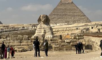 Sphinx with pyramids in the background.