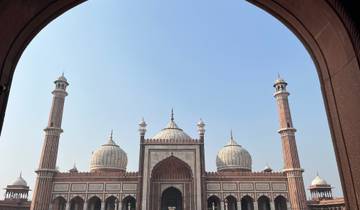 The façade of a mosque viewed through an ornate archway.