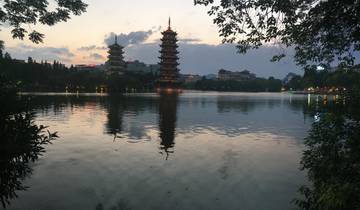 Pagodas reflecting on a lake at sunset