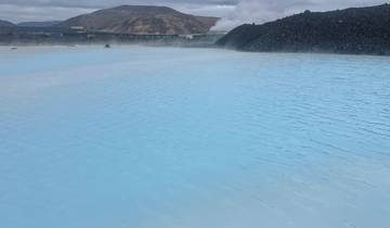 Blue lagoon with geothermal steam rising.