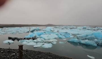 Serene view of a glacial lagoon with icebergs.