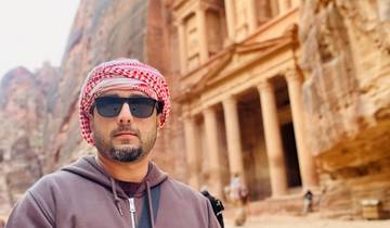 Individual standing in front of the famous rock-cut architecture site.
