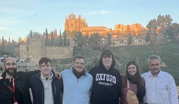 Group of people with a historic building in the background.