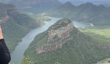 Scenic view of large rock formation and river.