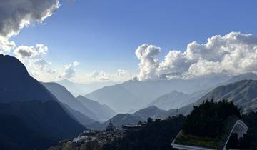 Dramatic view of mountains with cloud-filled sky.