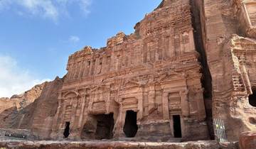 Petra's rock-carved architecture under a clear blue sky.