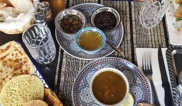 Traditional Moroccan meal with soup bowls and bread.