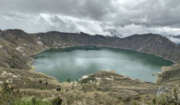 Picturesque view of a crater lake surrounded by hills.