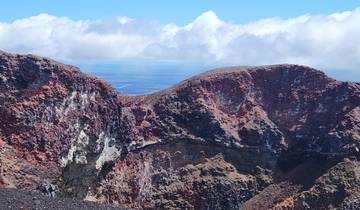 Spectacular view of a volcanic crater with colorful rock formations.