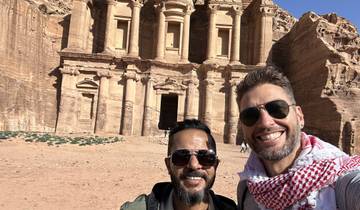 Two people in front of Petra’s rock-cut architecture