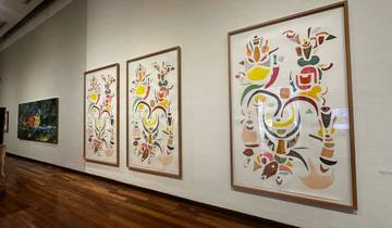 Art gallery with colorful paintings on display.