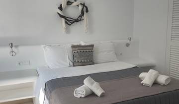 Minimalistic hotel room with neatly arranged towels.