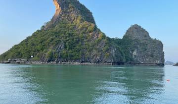 Majestic limestone karsts rising from the water.