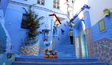 Vibrant blue alley with colorful decorations.