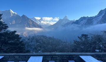 Mountain range with snow-capped peaks under a clear blue sky.