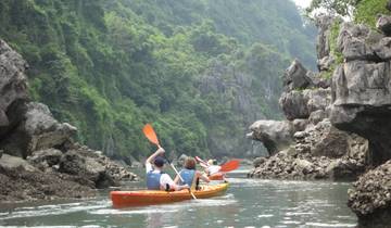 People kayaking through rock formations.
