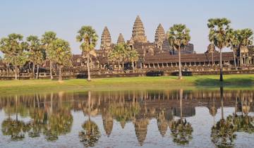 View of Angkor Wat temple reflected in a tranquil pond.