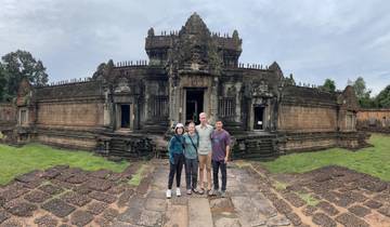 Four people posing in front of a historic Cambodian temple.