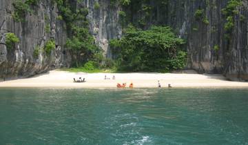 Sandy beach with two kayaks and people