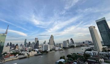 Cityscape with tall buildings along a river.