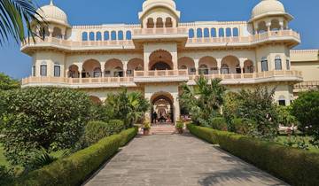 Majestic palace-like building with a garden pathway.
