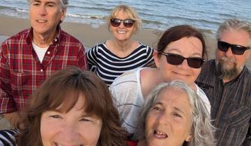 Group of people smiling at the beach.