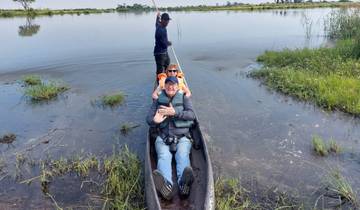 Tourists in a canoe on a waterway.