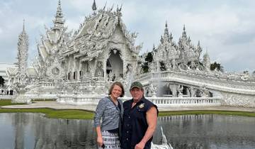 Couple standing in front of an ornate white temple.