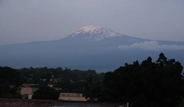 Mount Kilimanjaro with snowcap seen from afar.