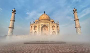 The Taj Mahal surrounded by mist and reflecting the sky.