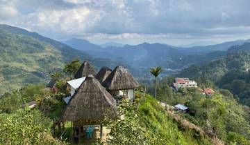Mountainous landscape with traditional huts.