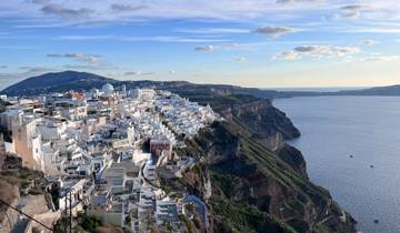 Cliffside village with white houses and sea view.