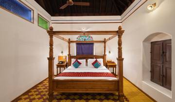 Well-furnished bedroom with traditional decor.
