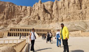 Visitors exploring the vast courtyard of Hatshepsut Temple.