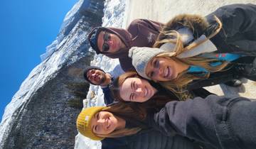 Group of people posing in a snowy landscape.