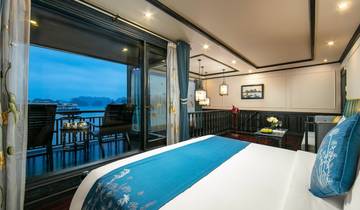A luxurious interior room with large windows overlooking a scenic water view.