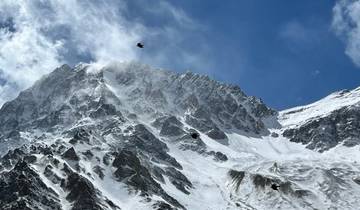 Snow-capped mountain peak against a blue sky.