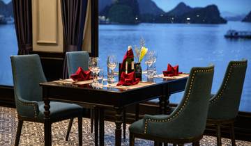Elegantly set dining table overlooking a bay.