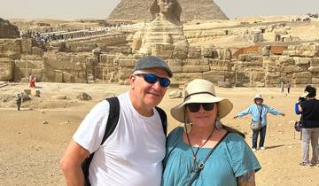 Two people posing with the Sphinx in the background.