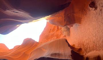 Sunlit walls of a canyon with textured surfaces.