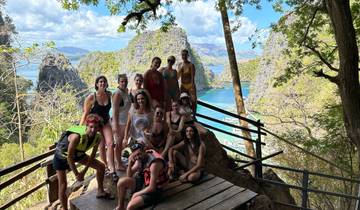 A group of people with rocky formations in the background.