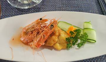 A dish with prawns and vegetables on a plate.