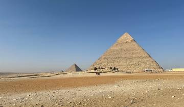 The Pyramids of Giza under a clear blue sky.