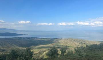 Scenic view of a lake with surrounding hills.