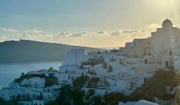 Santorini buildings at sunset with sea view.