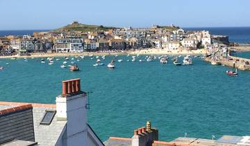 Harbor with boats and a view of a coastal town.