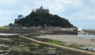 Pathway with people leading to a hilltop castle.