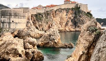 Scenic view of Dubrovnik's city walls and rocky coastline.